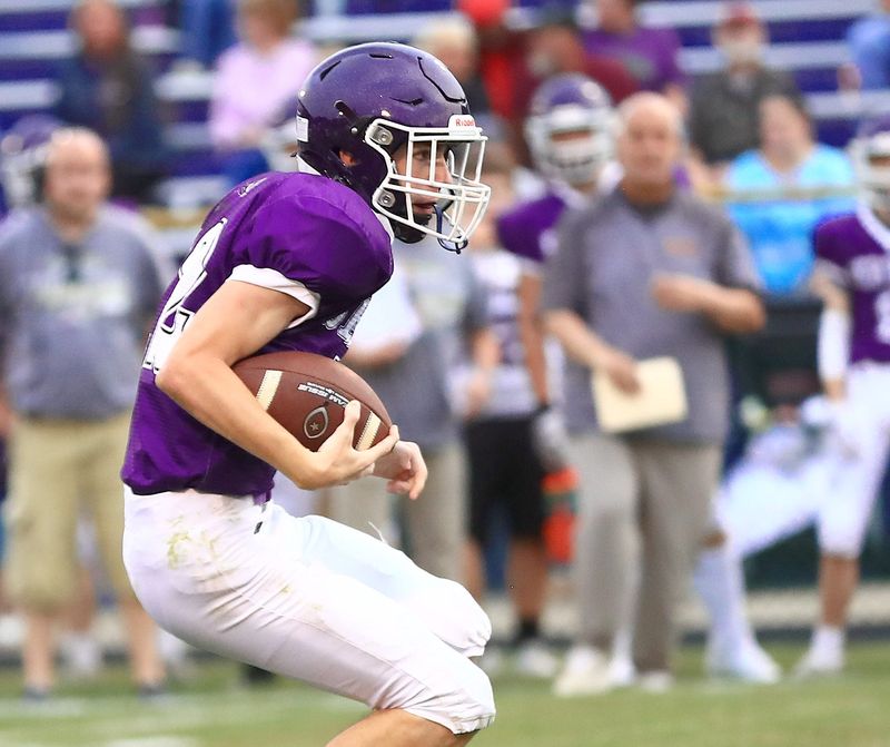 Sebring quarterback Zach Todd runs as head coach Anthony Agresta looks on during their game against St. Joseph Central Catholic, Friday, Sept. 5, 2025.