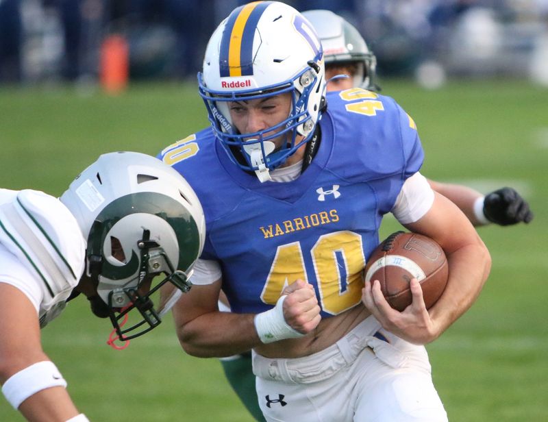 Ontario's Kooper Kilgore lowers his shoulder to gain extra yardage during the Warriors' 57-6 win over Madison on Friday night.