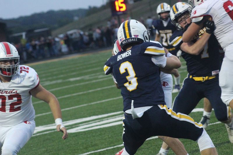 Hillsdale defensive back Brock Bower wraps up a Loudonville player.