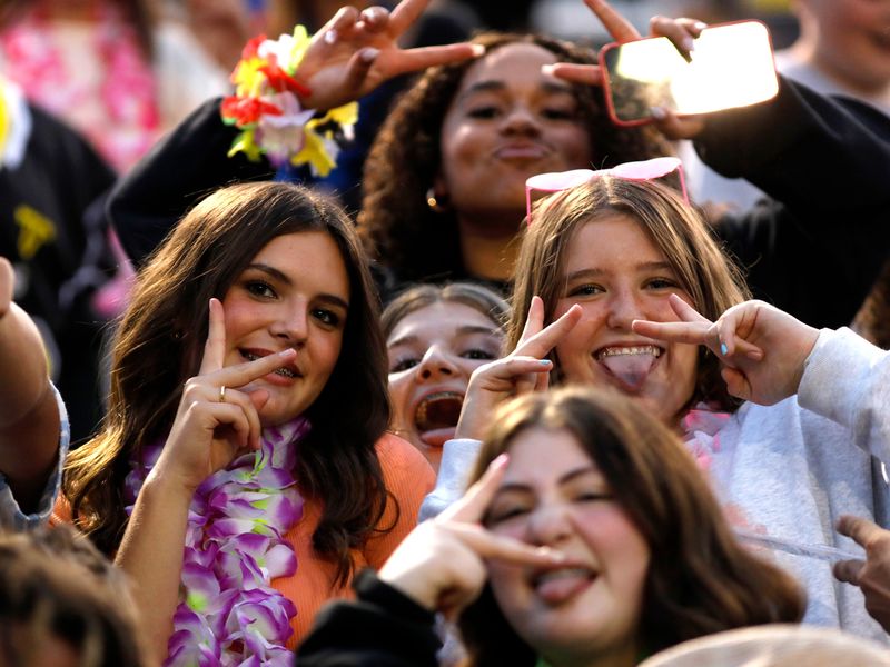 Students pose for photos during host Tri-Valley's 35-0 win against Clarksville Clinton-Massie on Friday, Sept. 5, 2025, at Jack Anderson Stadium in Dresden, Ohio.
