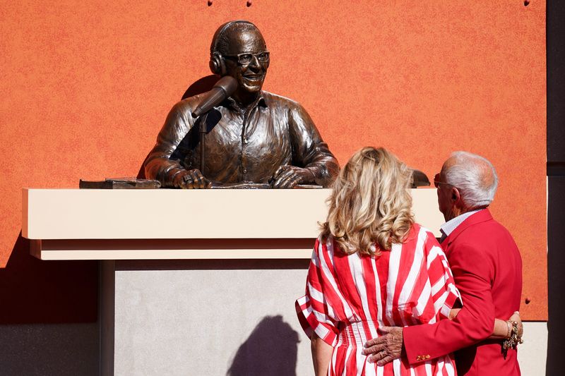 Amanda and Marty Brennaman observe the bronze statue of Marty at Crosley Terrace