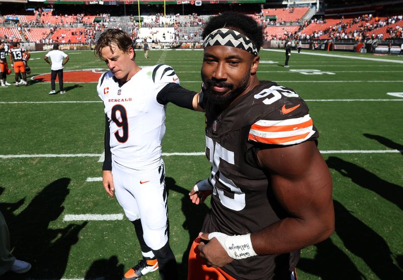 Sep 7, 2025; Cleveland, Ohio, USA; Cincinnati Bengals quarterback Joe Burrow (9) and Cleveland Browns defensive end Myles Garrett (95) greet each other after a game at Huntington Bank Field. Mandatory Credit: Scott Galvin-Imagn Images