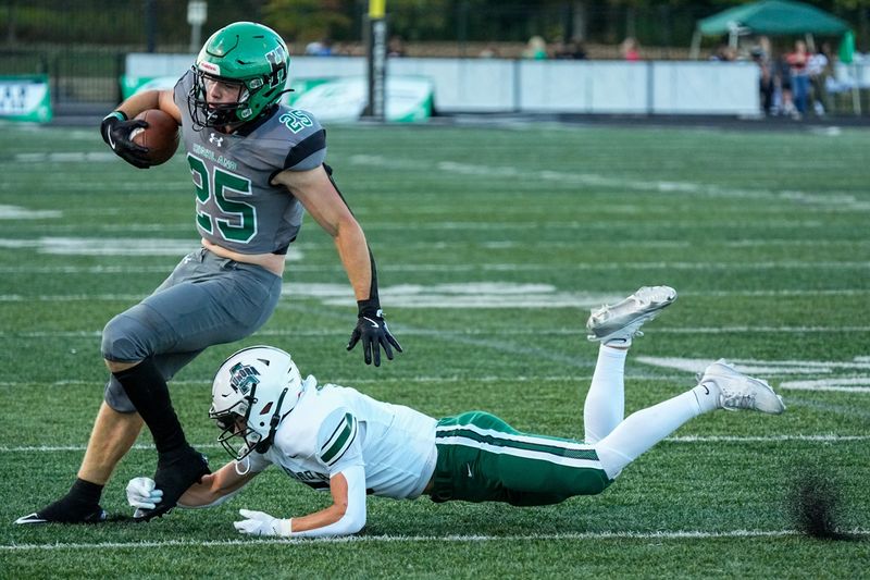 Casey Myser (25) of the Highland Hornets attempt to evade a shoestring tackle during a game against Aurora, Sept. 12, 2025, in Granger Township, Ohio.