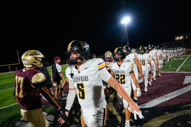 Upper Arlington's Grady McLafferty (5) low-fives New Albany's Mason Schumaker (17) after defeating New Albany at New Albany High School on Friday, Sept. 12, 2025 in New Albany, Ohio.