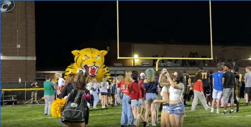 Fans mingle on the field after the final game at Clifford Stadium on Sept. 12, 2025, in Cuyahoga Falls.