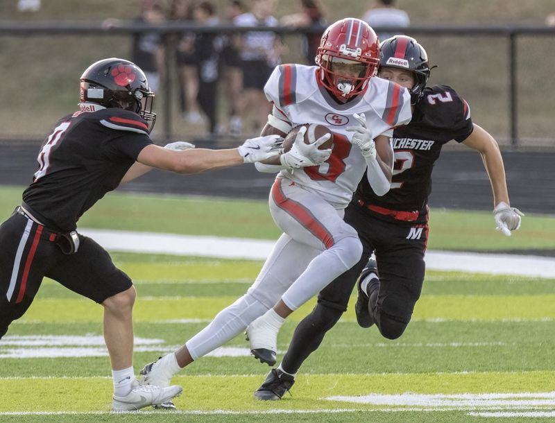 Canton South’s Brayton Carpenter cuts between Manchester’s Lorenzo Donatelli (8) and Malachi Cintron (20) on Friday, Sept. 12, 2025. Bob Rossiter / Special To The Canton Repository