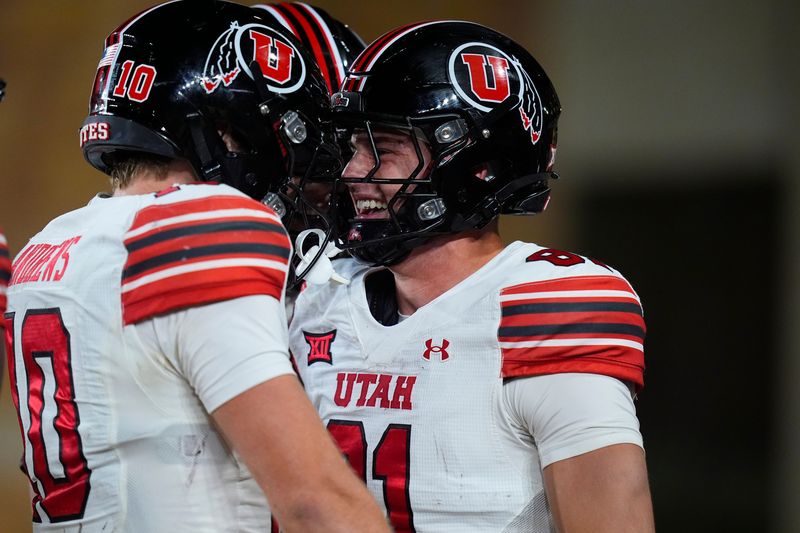 Sep 13, 2025; Laramie, Wyoming, USA; Utah Utes tight end JJ Buchanan (81) celebrates his touchdown reception with tight end Hunter Andrews (10) in the fourth quarter against the Wyoming Cowboys at Jonah Field at War Memorial Stadium. Mandatory Credit: Ron Chenoy-Imagn Images