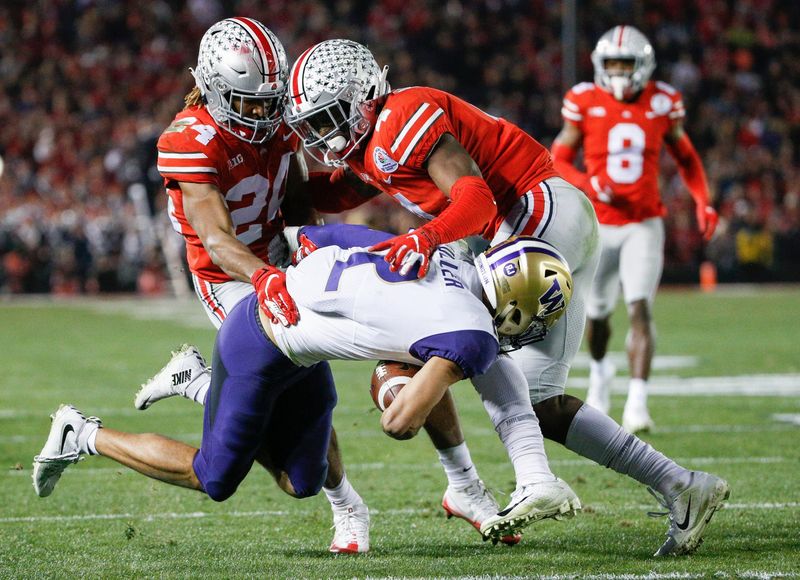Ohio State Buckeyes cornerback Shaun Wade (24) and Ohio State Buckeyes safety Jordan Fuller (4) bring down Washington Huskies wide receiver Aaron Fuller (2) after a reception during the fourth quarter of the 105th Rose Bowl Game between the Ohio State Buckeyes and the Washington Huskies on Tuesday, January 1, 2019 at the Rose Bowl in Pasadena, California. [Joshua A. Bickel/Dispatch]