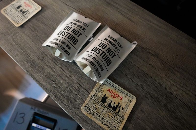 A cat sniffs A-Z Solutions radon testing equipment sit on a table at a resident’s home in Bexley on Tuesday, Sept. 9, 2025 in Columbus, Ohio.