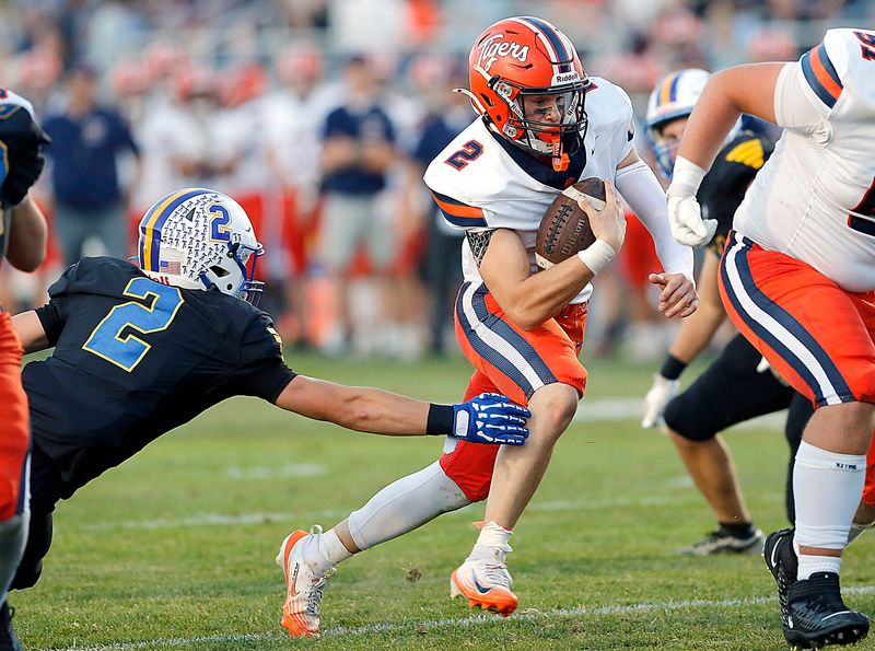 Galion High School's Samuel Evans (2) breaks a tackle by Ontario High School's Guy Trader (2) en route to his first quarter touchdown during high school football action Friday, Sept. 19, 2025 at Ontario High School. TOM E. PUSKAR/MANSFIELD NEWS JOURNAL