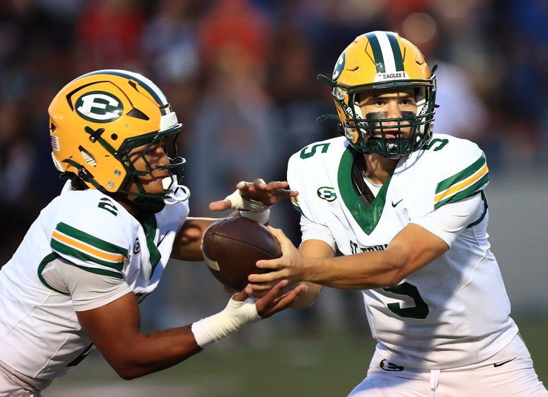 St. Edwards quarterback Jonny Evanchick, right, hands the ball off to Brandon White during action Friday night, September 19, 2025 at Paul Brown Tiger Stadium. Ed Hall Jr. / Special To The Repository