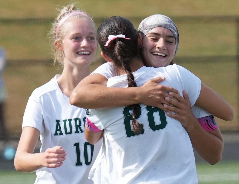 Aurora’s Caitlin Miller looks on as Juilana Huth congratulates Abby Dalessandro’s goal in first half of the game against Streetsboro at Rockets Stadium at Streetsboro High School on Sept. 20, 2025.