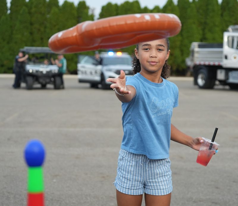 Aubree Roberts, 9, of Jackson Township plays the ring toss game with an inflatable pretzel at the recent Jackson Township Oktoberfest and Fall Festival held at the Nash Family Jackson Amphitheater. The event was sponsored by the Canton Regional Chamber of Commerce.