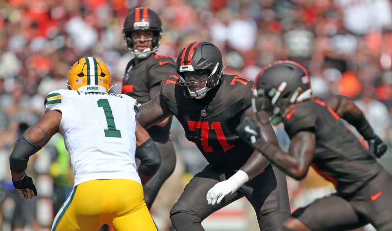 Green Bay Packers linebacker Micah Parsons (1) tries to get around Cleveland Browns offensive tackle Cornelius Lucas (71) during the first half of an NFL football game at Huntington Bank Field, Sept. 21, 2025, in Cleveland, Ohio.