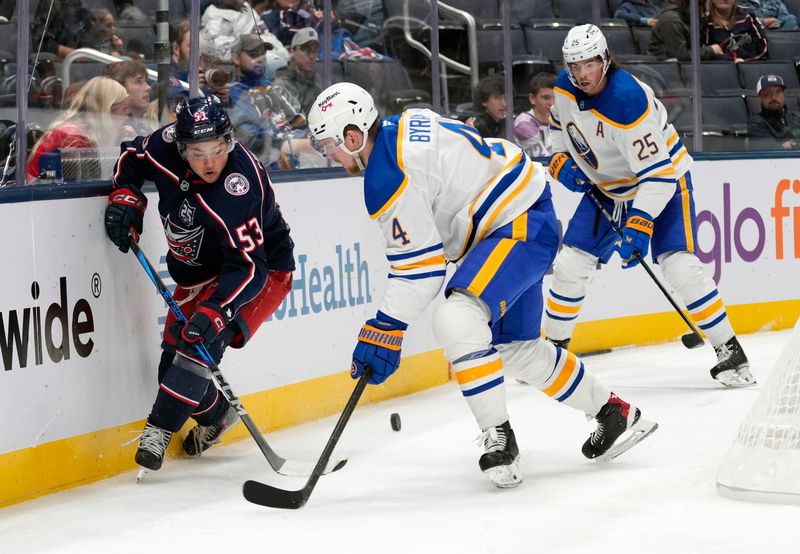 Columbus Blue Jackets center Luca Pinelli (53) battles for the puck against against Buffalo Sabres defenseman Bowen Byram (4) during the third period of their preseason game at Nationwide Arena on Sept. 22, 2025.