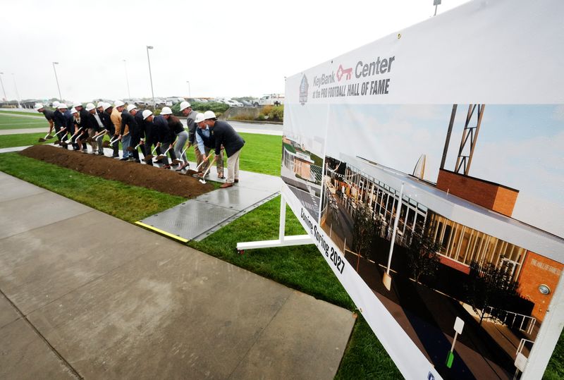 Dignitaries turn over ceremonial dirt Tuesday, Sept. 23, 2025, at a groundbreaking for the Pro Football Hall of Fame's new KeyBank Center in Canton.