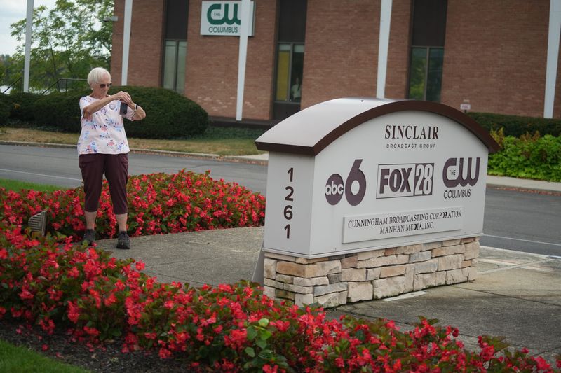 A woman photographs the company sign Sept. 23 as the local justice and human rights advocacy group Indivisible Central Ohio held a protest outside Columbus' ABC affiliate station WSYX ABC 6 & WTTE FOX 28 in protest of the company's Sept. 17 suspension of Jimmy Kimmel's late-night show.