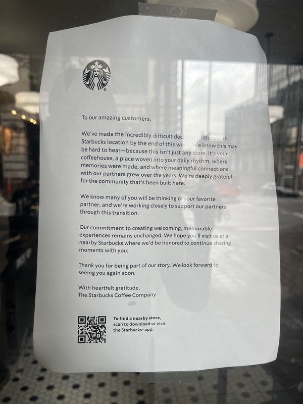 A sign taped to the front door of the Starbucks on Vine Street in downtown Cincinnati announces the location's closure.
