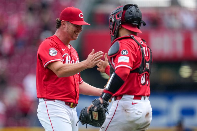 Cincinnati Reds relief pitcher Emilio Pagan (15) and catcher Jose Trevino (35) celebrate a win after the ninth inning of the MLB National League game between the Cincinnati Reds and the Pittsburgh Pirates at Great American Ball Park in downtown Cincinnati on Thursday, Sept. 25, 2025. The Reds won, 2-1.