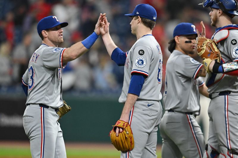 Texas Rangers right fielder Billy McKinney, left, and relief pitcher Phil Maton celebrate after the Rangers beat the Cleveland Guardians on Sept. 26, 2025, in Cleveland.