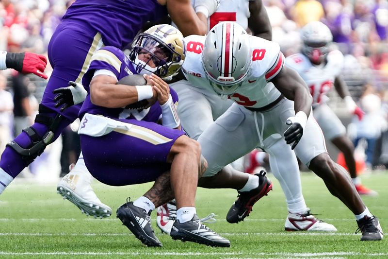 Ohio State Buckeyes linebacker Arvell Reese (8) tackles Washington Huskies quarterback Demond Williams Jr. (2) during the first half of the NCAA football game at Husky Stadium in Seattle on Sept. 27, 2025.