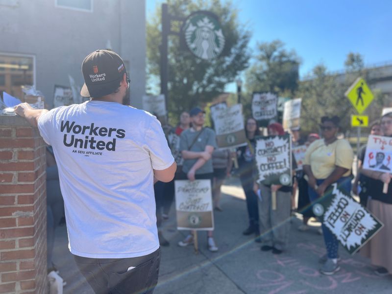 Jacob Welsh, a field organizer with Workers United and a former Starbucks employee, addresses the crowd at a Starbucks picket outside a store at 1784 N. High St. in Columbus' University District on Sept. 28, 2025, where attendees demanded the corporation settle a fair union contract.