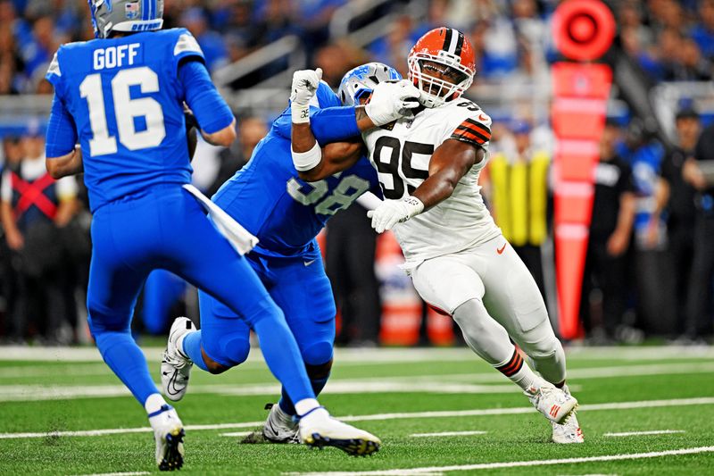 Sep 28, 2025; Detroit, Michigan, USA; Cleveland Browns defensive end Myles Garrett (95) tries to get around Detroit Lions offensive tackle Penei Sewell (58) during the second half at Ford Field. Mandatory Credit: Lon Horwedel-Imagn Images