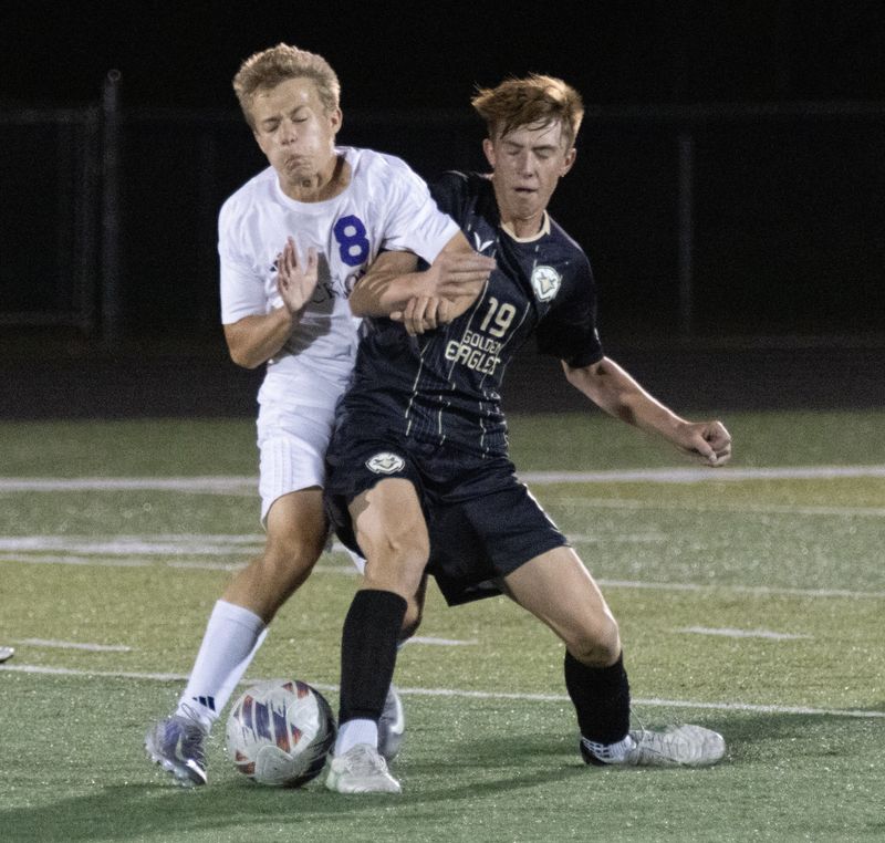 Jackson’s Carter Feiber (left) and GlenOak’s Ian Meyer compete for the ball, Tuesday, Sept. 30, 2025.