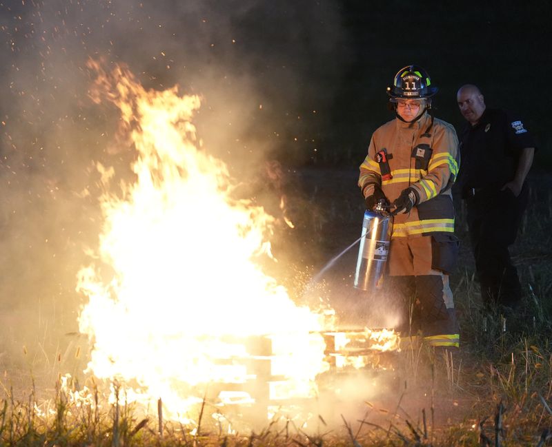 Erie Valley firefighter/medic Mike Nichols uses a can filled with SoyFoam and water to put out a pallet fire during a demonstration of its effectiveness in real-world firefighting situations at Cedar Crest Farm in Bethlehem Township.