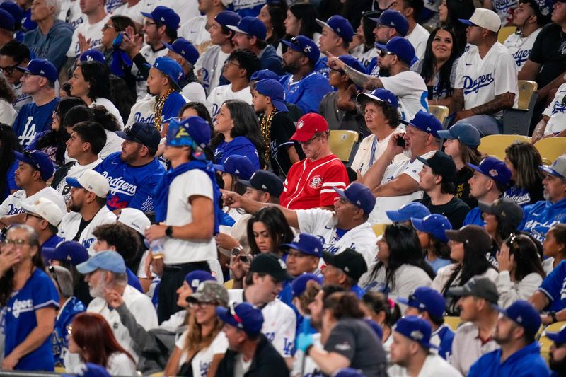 A lone Reds fan sits among Dodgers fans