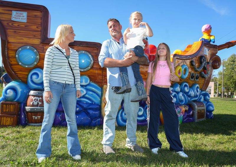 Ben Gulley, center, is planning to open a new indoor park along Cherry Road NW in Massillon for children who have special needs. Gulley is pictured holding his 6-year-old son, Gabriel, who has autism, in addition to Gabe's mother, Cassie Kennedy, left, and his daughter, Lana Gulley, 11.