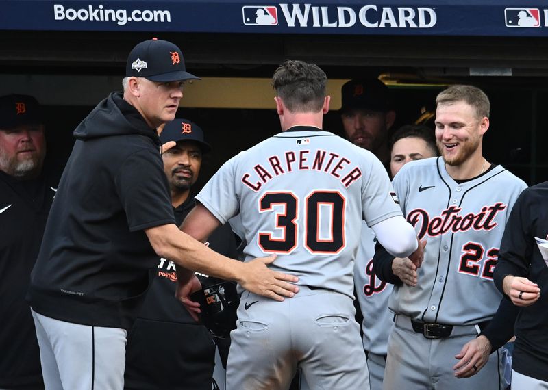 Oct 2, 2025; Cleveland, Ohio, USA; Detroit Tigers outfielder Kerry Carpenter (30) celebrates with teammates after scoring in the seventh inning against the Cleveland Guardians during game three of the Wildcard round for the 2025 MLB playoffs at Progressive Field. Mandatory Credit: Ken Blaze-Imagn Images