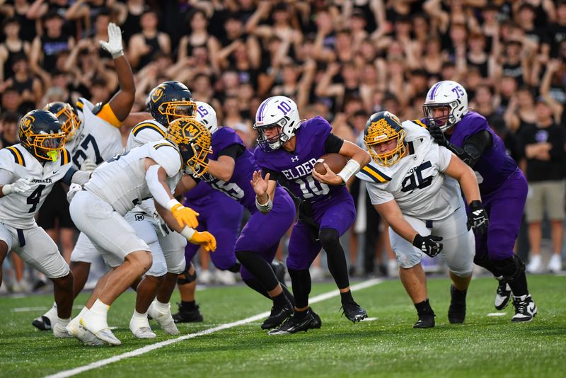 Elder quarterback Kaden Estep (10) carries the ball during the high school football game between Archbishop Moeller and Elder at The Pit on Friday, Oct. 3, 2025. Elder defeated Moeller 24-16.