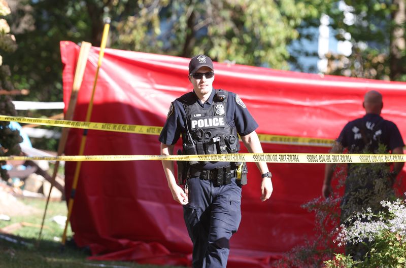 Massillon police and firefighters erected a barrier with tarps to block the view of a person killed in a garage explosion at 17th Street NE and Lindbergh Avenue NE in Massillon.