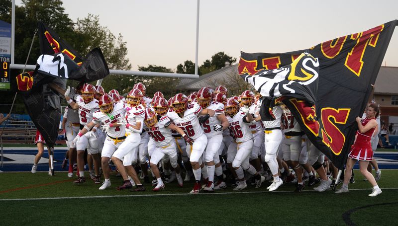 Big Walnut players run onto the field Oct. 3, 2025, at Worthington Kilbourne. (photo by John Hulkenberg)