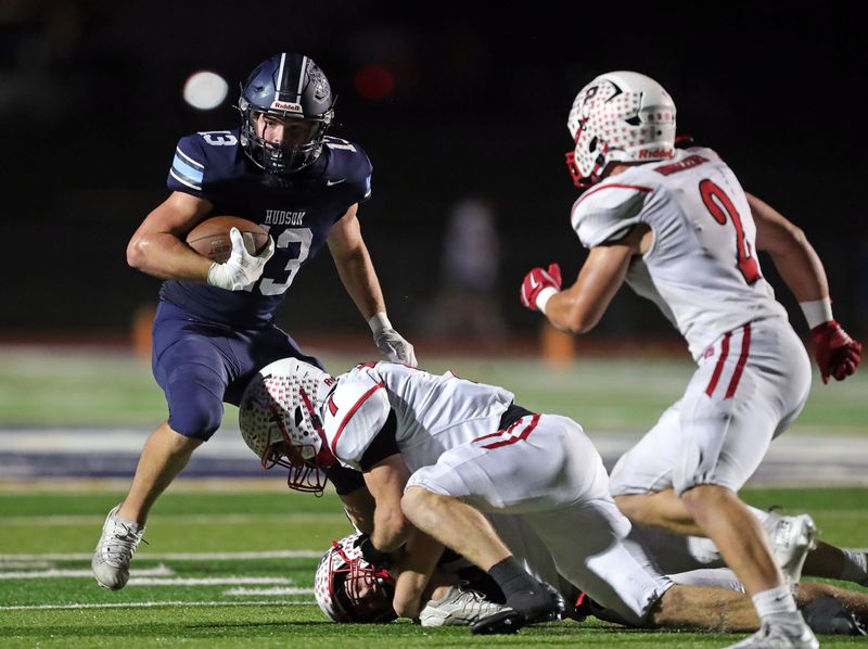 Hudson tight end Christopher Horner (13) is brought down by a pair of Wadsworth defenders during the second half of a high school football game, Oct. 3, 2025, in Hudson, Ohio.