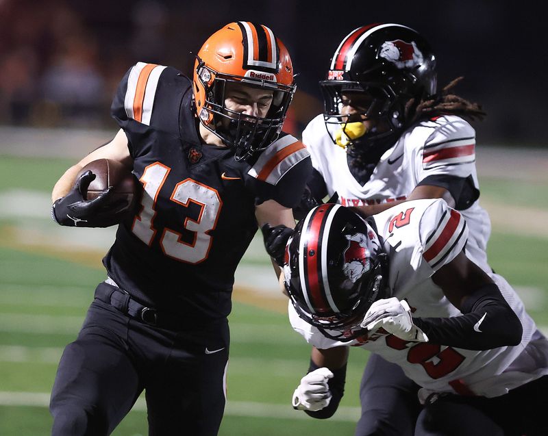 Hoover's Michael Lammlein picks up yards during a high school football game against McKinley in North Canton on Friday, October. 3, 2025.