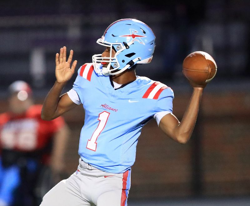 Alliance quarterback JR Jackson throws down field against Carrollton at Kehres Stadium, Friday, Oct. 3, 2025.