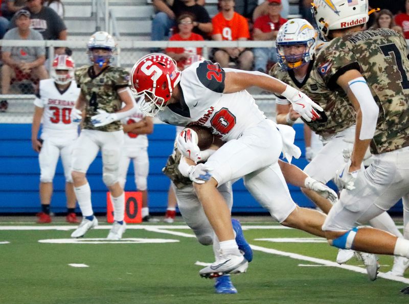 Sheridan's Logan Russell fights for extra yards during the first quarter of Sheridan's 28-7 win against Philo in a high school football game on Friday, Oct. 3, 2025, in Duncan Falls, Ohio. Russell ran 28 times for 200 yards.
