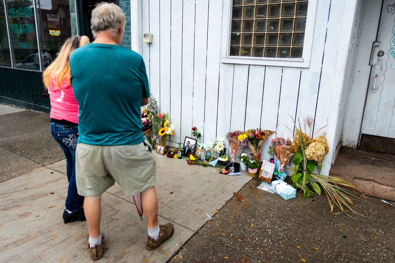 A memorial to Wooster resident Timothy Hutchinson is seen Oct. 7 at 816 West Market St. in Akron, Ohio. Hutchinson was shot dead in an apparent cross fire shooting between people around 12:35 a.m., Oct. 5 in Highland Square, authorities said.