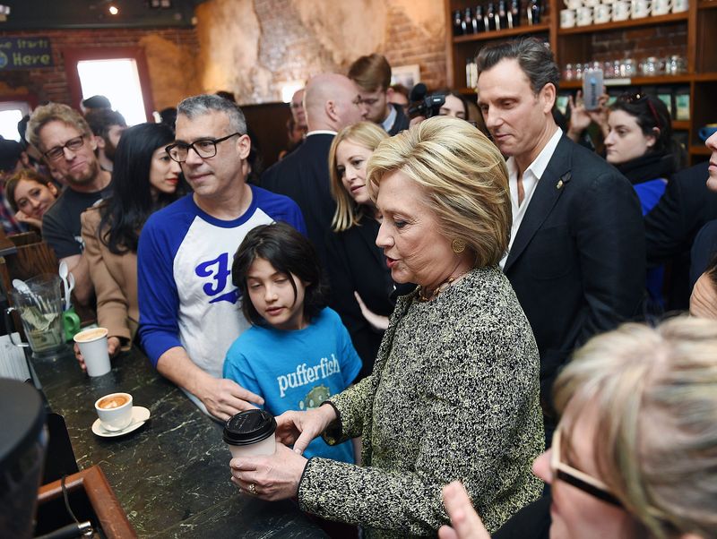 Democratic presidential candidate and former Secretary of State Hillary Clinton, center, makes a campaign stop at the popular Fido on Feb. 28, 2016. Enjoying the moment is Fido owner Bob Bernstein, in white and blue shirt.