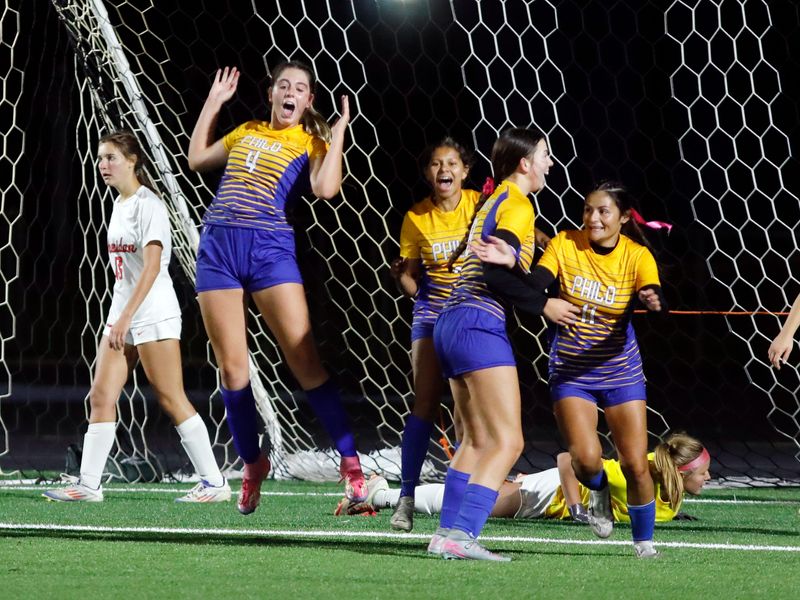 Lia Unger, left, Victoria Ligon and Reagan Miller celebrate with Angie Myers, right, after her go-ahead goal in the second half of Philo's 2-1 win against visiting Sheridan on Oct. 9, 2025, in Duncan Falls, Ohio.