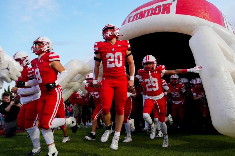 London's Bryston Toronto (20) takes the field with his teammates before the game against Jonathan Alder at London High School on Friday, Oct. 10, 2025 in London, Ohio.