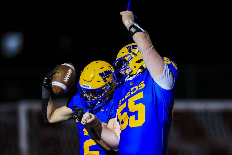 Newport Central Catholic running back Eddie Bivens (2) reacts after scoring a touchdown with offensive tackle Will Sandfoss (55) in the second half against Newport at Dixie Heights High School Oct.10, 2025.