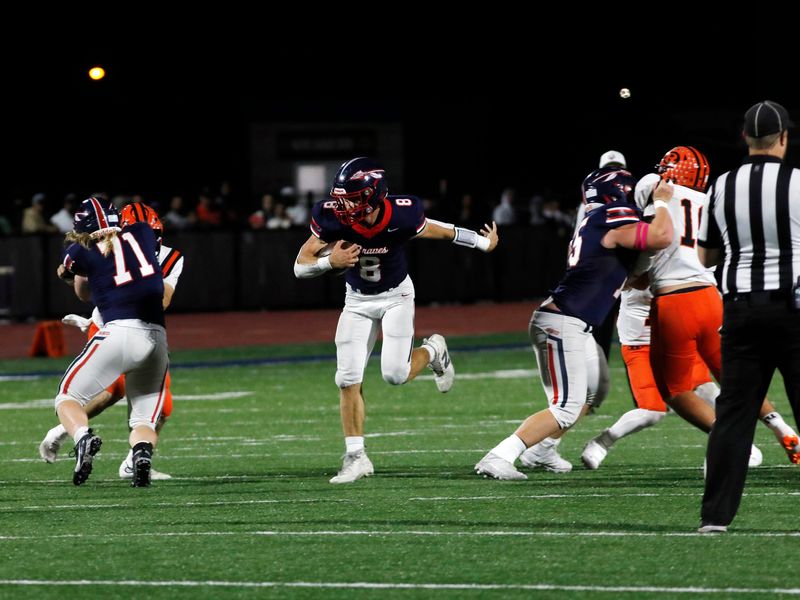 Ryker Williams runs through a hole created by linemen Koy Haney, left, and Brogan O'Connor during Indian Valley's 42-14 win against visiting Ridgewood on Friday, Oct. 10, 2025, in Gnadenhutten, Ohio. Haney and O'Connor were starters on last year's Division IV state championship team.