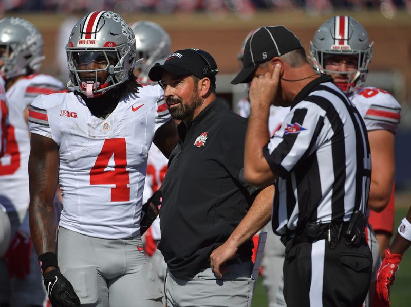 Oct 11, 2025; Champaign, Illinois, USA; Ohio State Buckeyes head coach Ryan Day talks with wide receiver Jeremiah Smith (4) during the second quarter against the Illinois Fighting Illini at Memorial Stadium. Mandatory Credit: Ron Johnson-Imagn Images