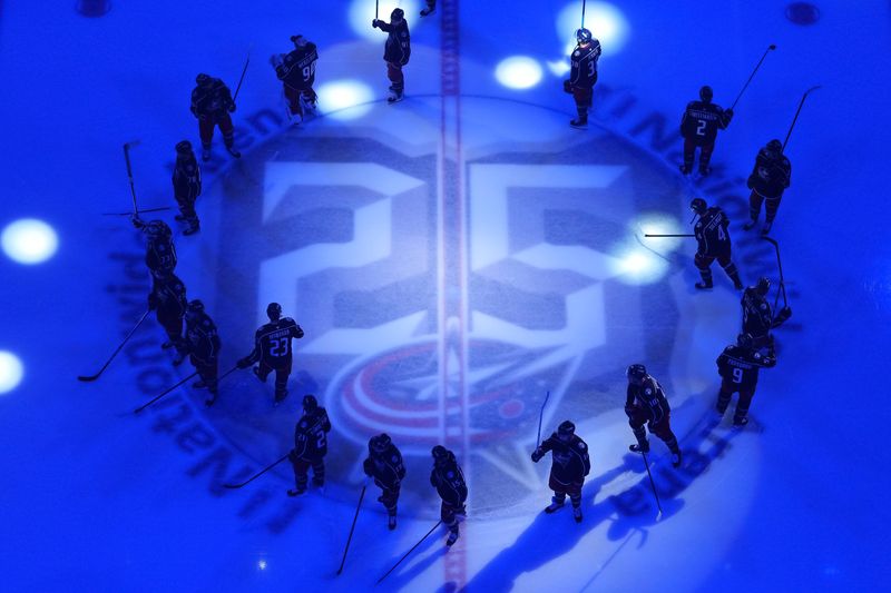 The Columbus Blue Jackets are introduced at center ice prior to the home opening NHL hockey game against the New Jersey Devils at Nationwide Arena in Columbus on Oct. 13, 2025. The center ice logo commemorates the 25th season for the Blue Jackets.