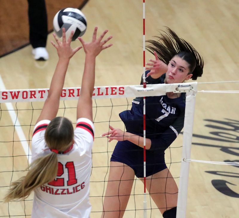 Hoban’s Samantha Dehrmann, right, hits the ball over Wadsworth’s Rowan Kelly during the first set of a high school volleyball match, Oct. 14, 2025, in Wadsworth, Ohio.