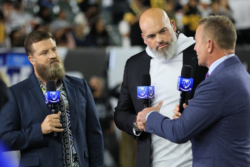 Oct 16, 2025; Cincinnati, Ohio, USA; Amazon Prime Thursday Night Football analysts Ryan Kirkpatrick (left), Andrew Whitworth (center) and Kirk Herbstreit talk on the field during halftime of the game between the Pittsburgh Steelers and the Cincinnati Bengals at Paycor Stadium. Mandatory Credit: Katie Stratman-Imagn Images