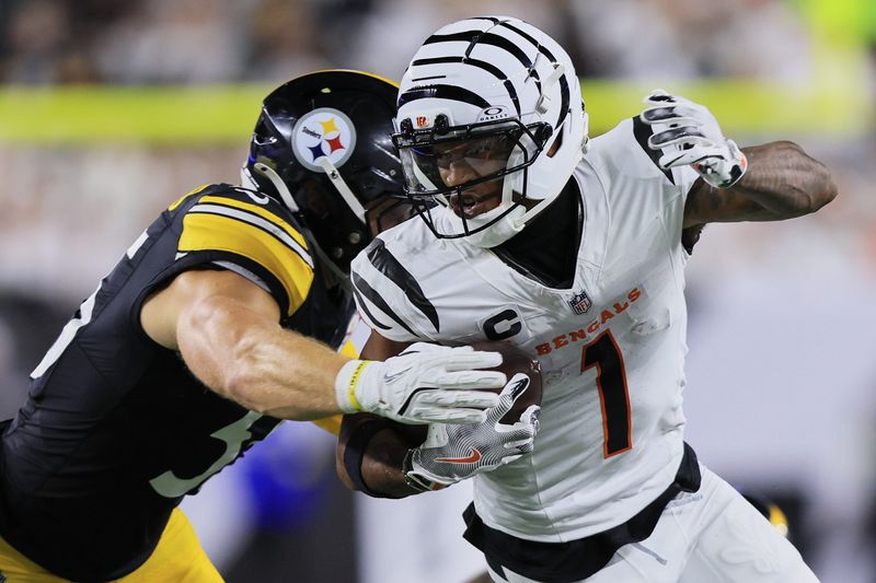 Oct 16, 2025; Cincinnati, Ohio, USA; Cincinnati Bengals wide receiver Ja'Marr Chase (1) runs with the ball against Pittsburgh Steelers linebacker Cole Holcomb (55) during the second quarter at Paycor Stadium. Mandatory Credit: Katie Stratman-Imagn Images
